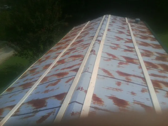 Rusted metal roof panels with new wood purlins before replacement — Storm Damage Roof Repair in Haskell by Roofing Brothers